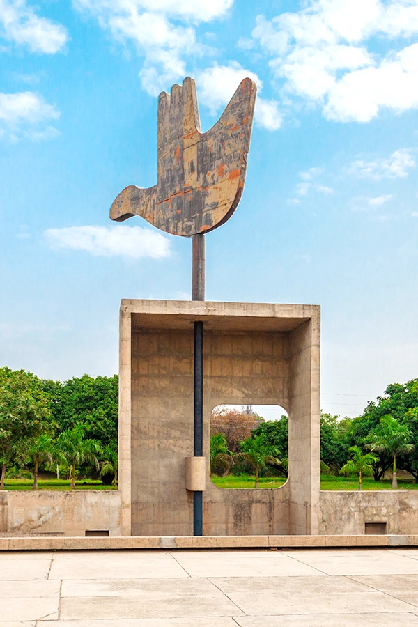 Open Hand Monument in Chandigarh, India, against a blue sky with clouds.