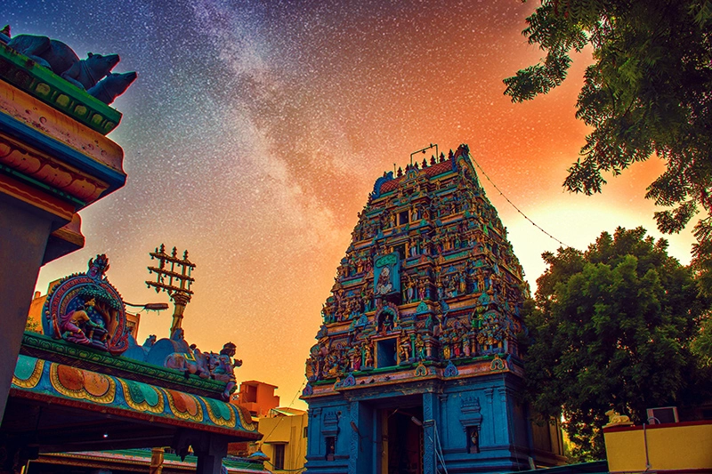 Colorful Ekambareswarar Hindu temple in Chennai, Tamil Nadu, under a starry sky.