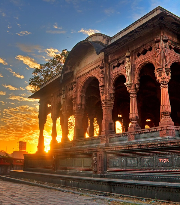 Krishna Pura Chhatri in Indore, featuring a sunset behind its ornate architecture.